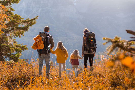 A family with Scout & Explorer hiking backpacks in the fall