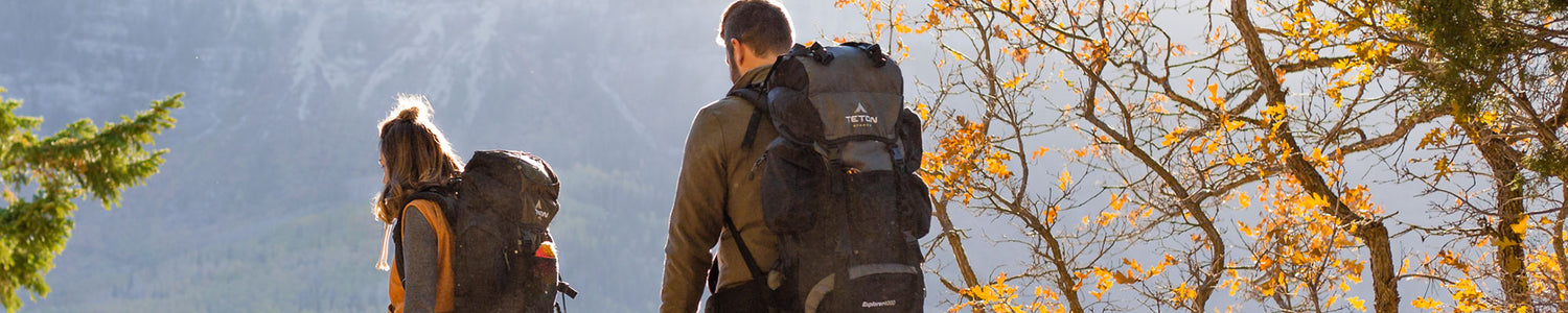 A man and woman with hiking backpacks