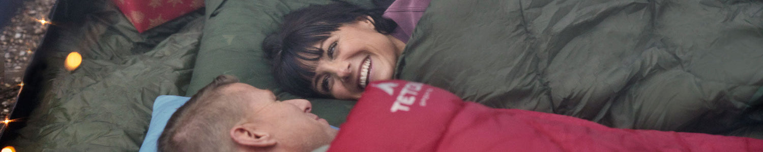 A man and woman in their Celsius sleeping bags