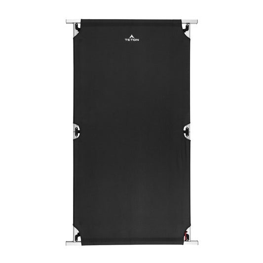 Black camping cot with metal frame on a white background