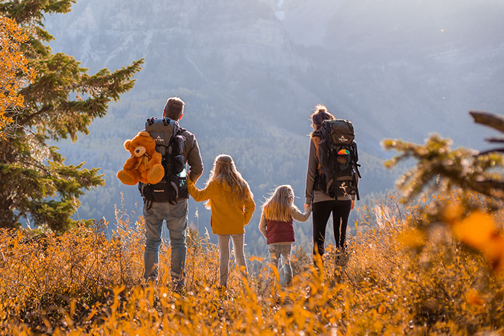 A family with Scout & Explorer hiking backpacks in the fall