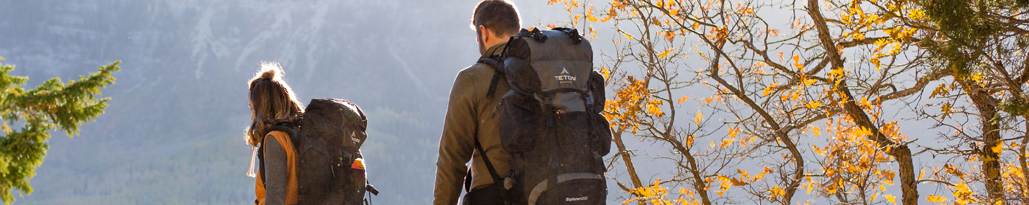A man and woman with hiking backpacks