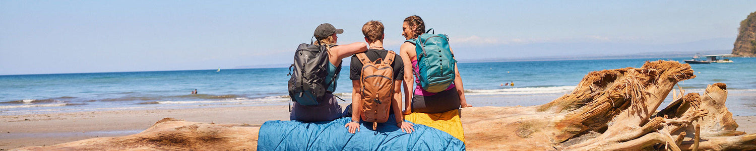Friends at a beach with Numa packs