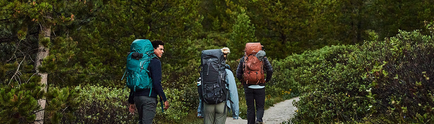 Three friends hiking with their Signal backpacks