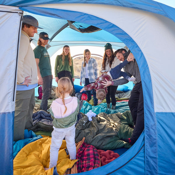 A family standing inside the hacienda tent with vertical sidewalls.