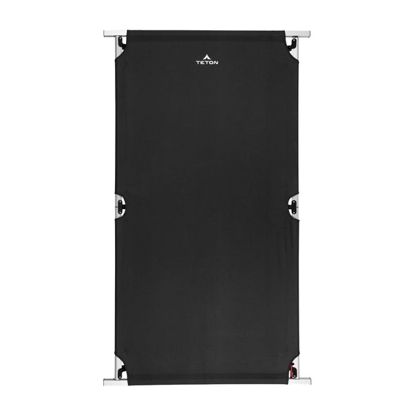 Black camping cot with metal frame on a white background