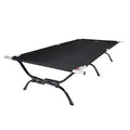 Black camping cot with metal frame on a white background