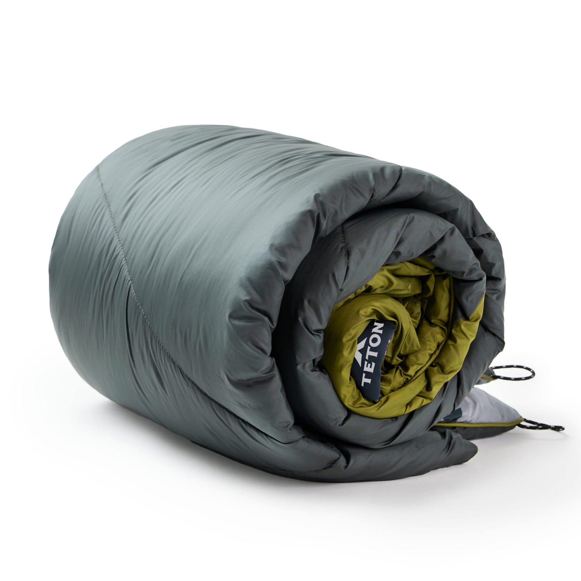 Rolled green outdoor blanket with Teton brand logo on a white background