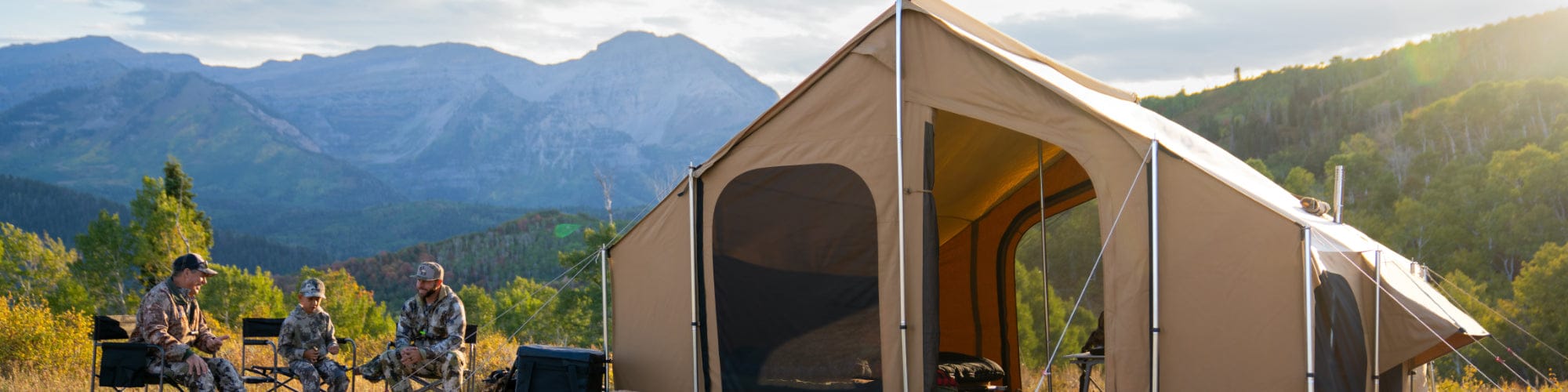 3 people sitting outside the timpanogos tent