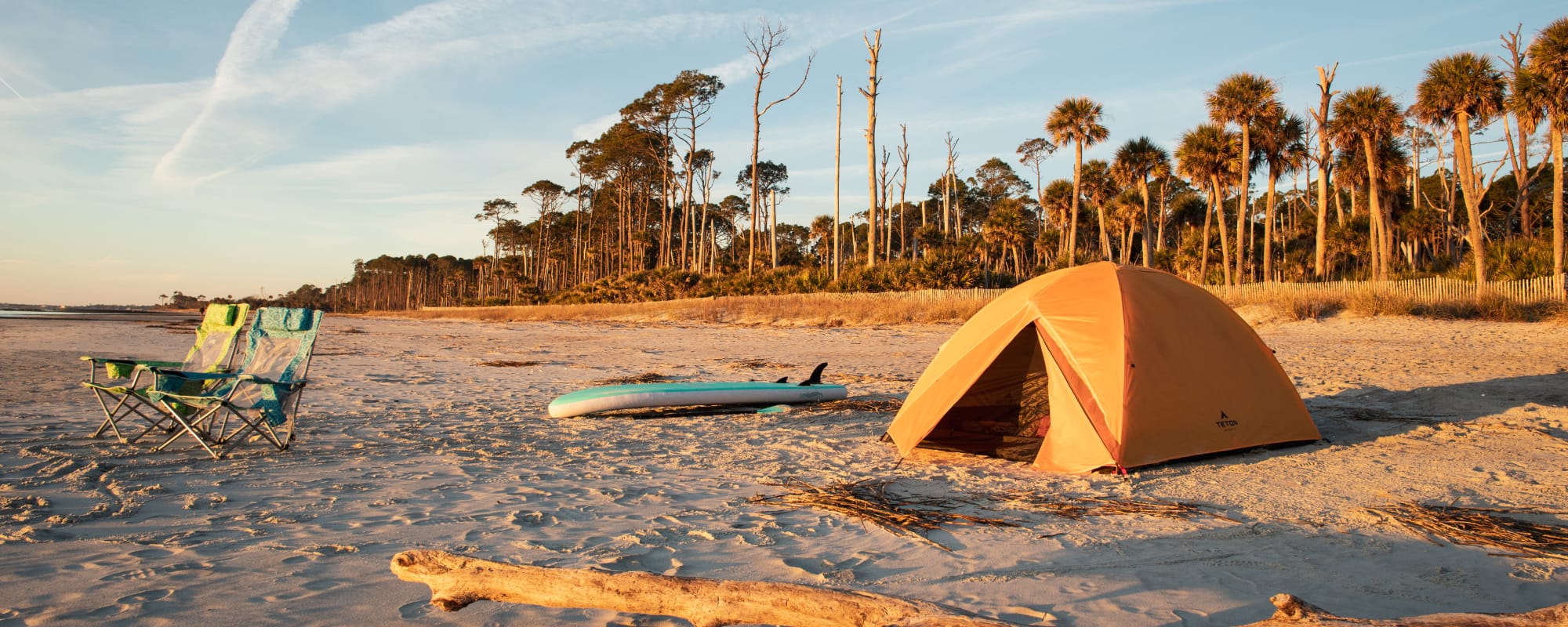 Yellow Mountain Ultra tent on a sandy beach with palm trees in the background