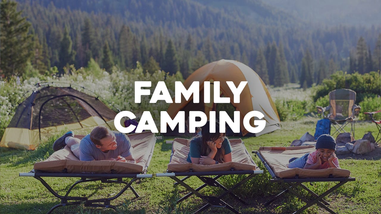 Family camping scene with tents, camping cots in a forest setting with "Family Camping" text overlay