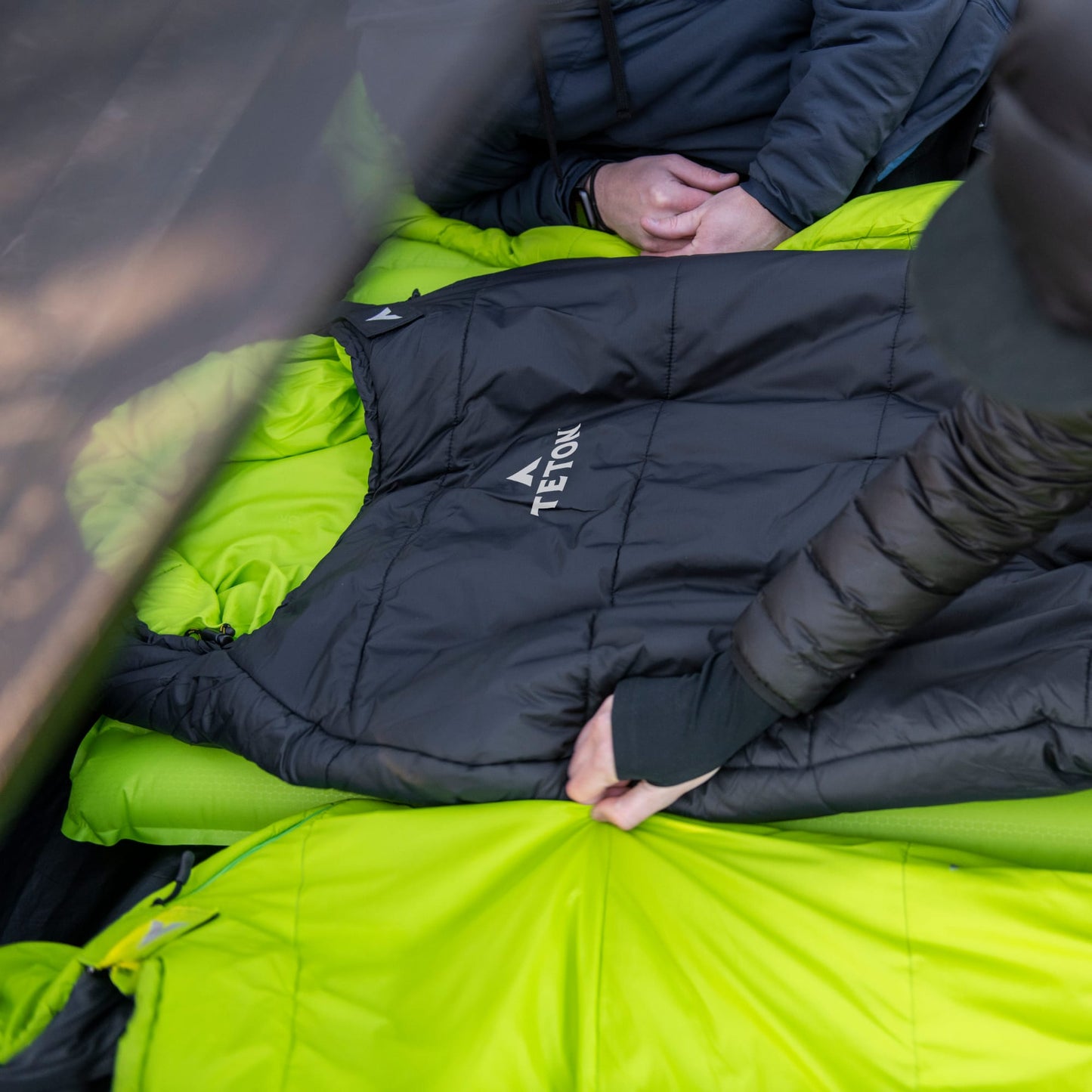 Person setting up a mummy sleeping bag