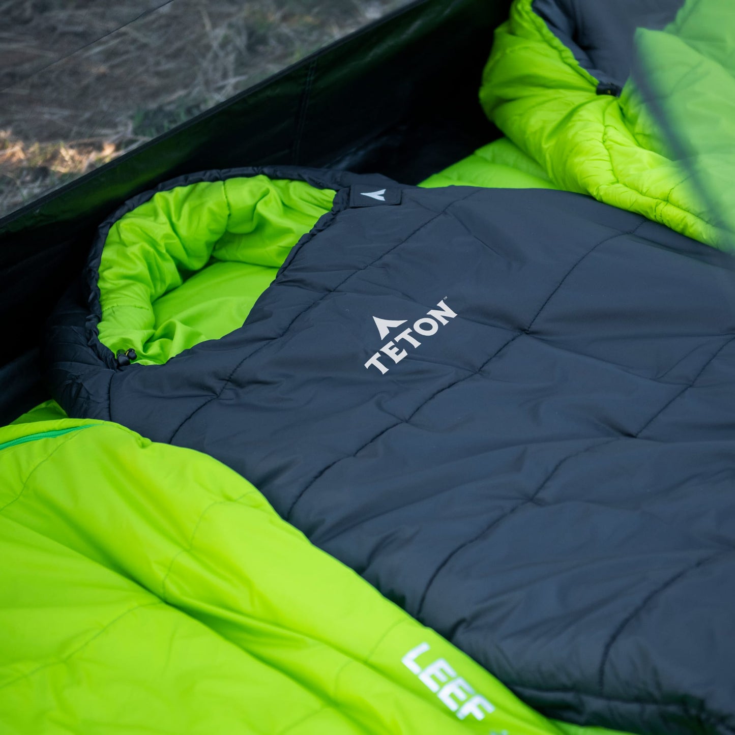 Green and black mummy sleeping bags with Teton brand logo