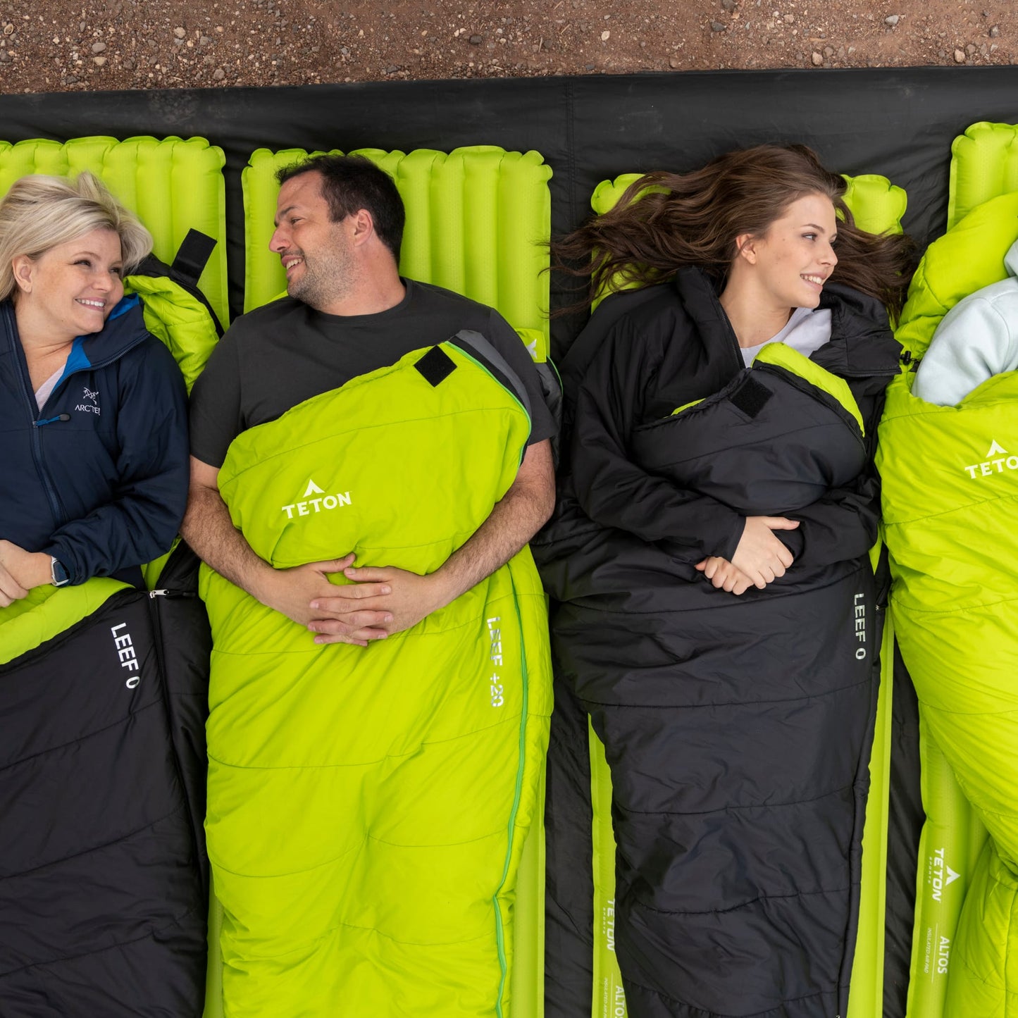 3 people lying on leef mummy sleeping bags 
