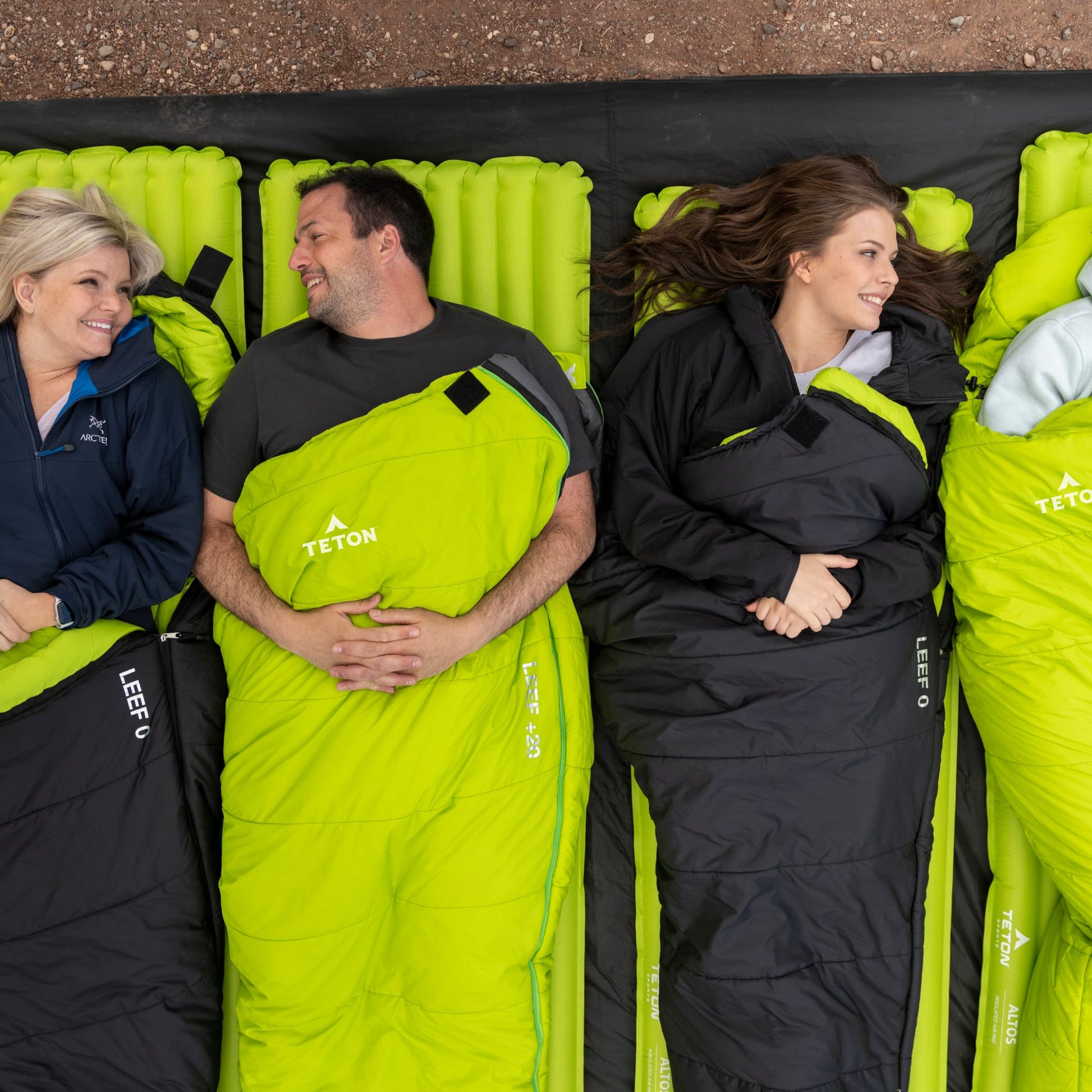 3 people lying on leef mummy sleeping bags 