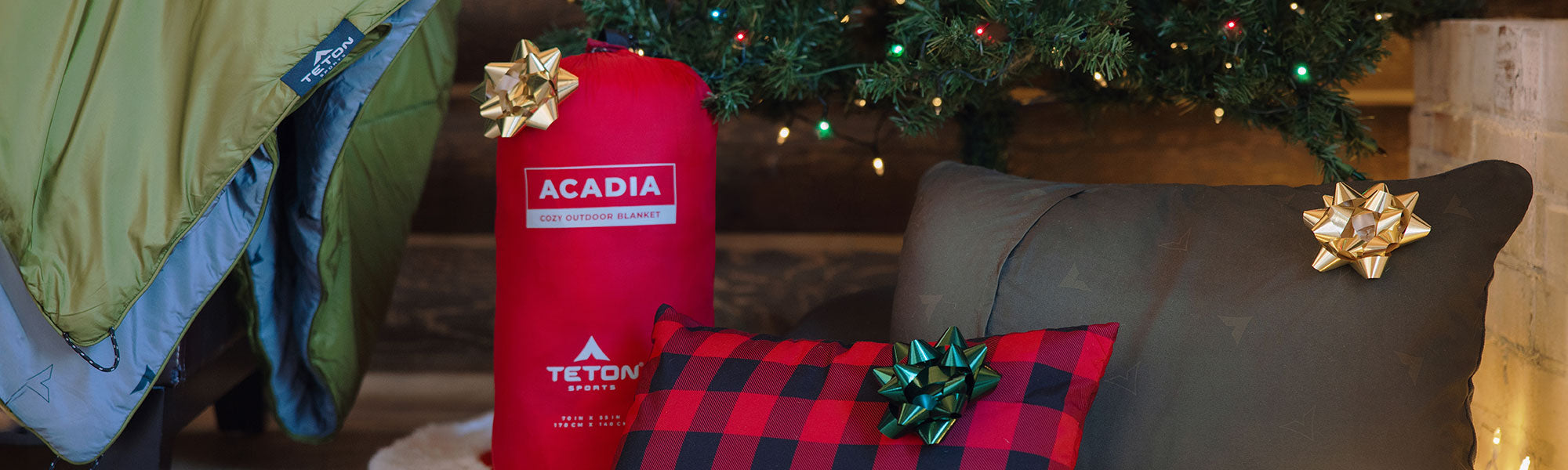 Pillows and blankets wrapped under the tree.