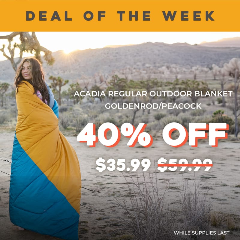 A promotional outdoor photo shows a woman wrapped in a yellow and blue blanket standing in a desert landscape at sunset. Large text reads 'DEAL OF THE WEEK,' 'ACADIA REGULAR OUTDOOR BLANKET - GOLDENROD/PEACOCK,' '40% OFF,' Final Price $35.99.