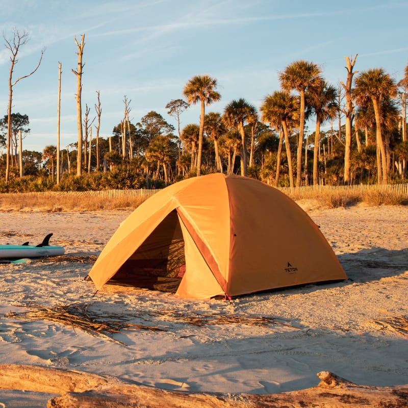 Yellow Mountain Ultra tent on a sandy beach with palm trees in the background