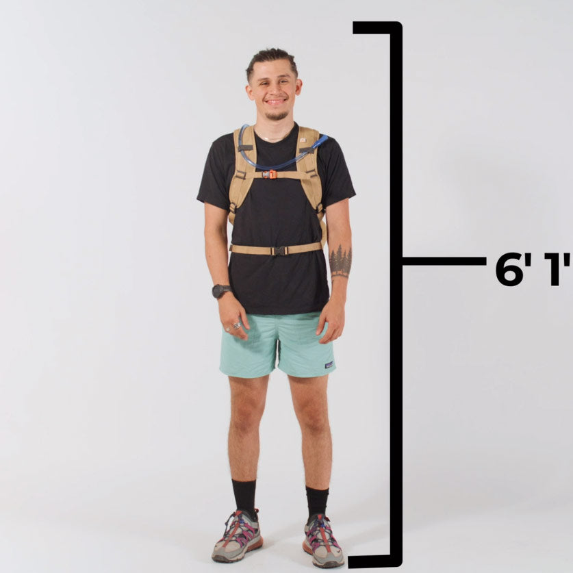 A man wears a TETON Sports Oasis 22L Hydration Pack on camera.